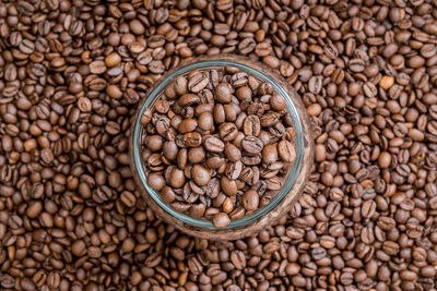 Close-up of roasted coffee beans with container