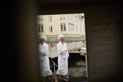 Senior woman wearing dressing gown at sea