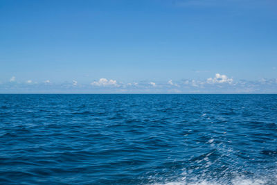 Scenic view of sea against blue sky