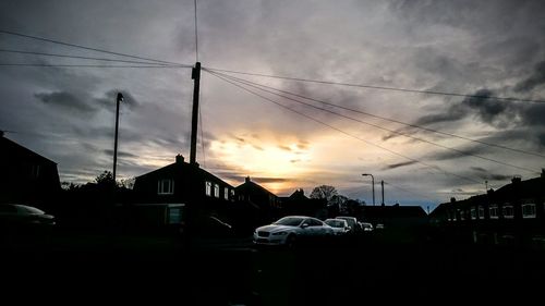 Built structures against sky at sunset