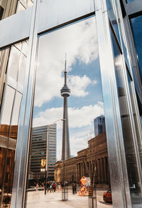 Reflection of cn tower in a window of a building in toronto, canada.