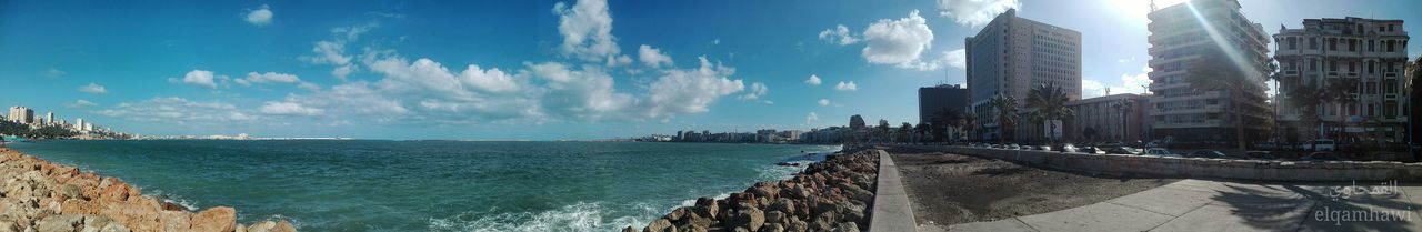 sea, architecture, water, built structure, building exterior, sky, skyscraper, day, sunlight, city, outdoors, no people, panoramic, nature, cityscape, beauty in nature, horizon over water, wave