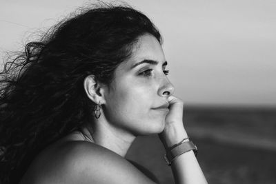 Close-up portrait of young woman looking away