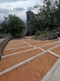 View of footpath amidst buildings against sky