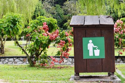 Information sign on street by trees