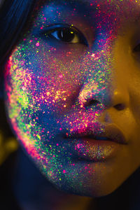 Portrait of beautiful young woman with face paint