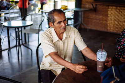 Portrait of senior man working in workshop