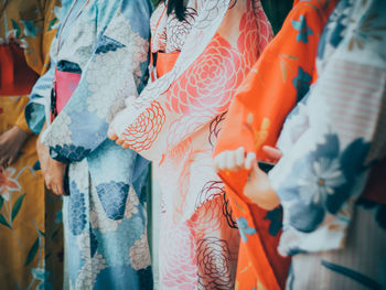 Midsection of women wearing traditional clothes