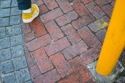 Low section of person standing on footpath