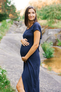 Portrait of young woman standing outdoors