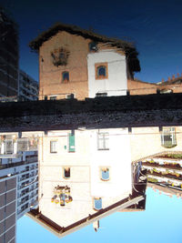 Low angle view of residential buildings against blue sky