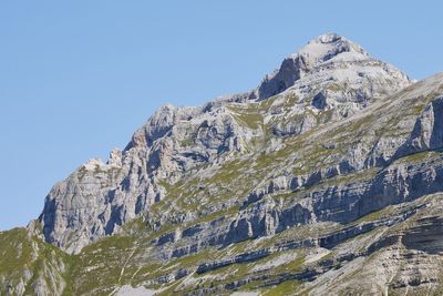 Low angle view of rock formation against clear sky