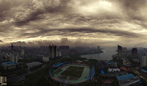 Cityscape against cloudy sky