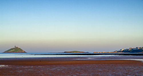 Scenic view of beach against clear sky