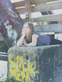 Cute girl relaxing on wall