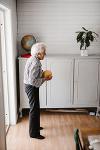 Senior woman holding ball