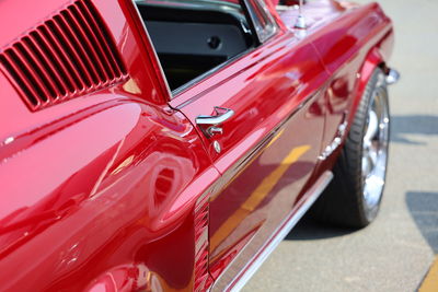 Close-up of red car on road in city