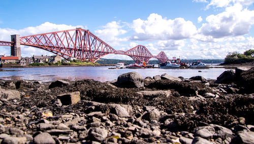 Bridge over sea against sky in city