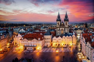 High angle view of illuminated buildings against sky at sunset