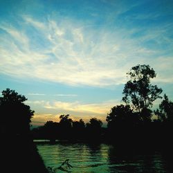 Scenic view of lake against cloudy sky