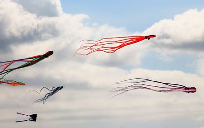 Low angle view of flag flying against sky