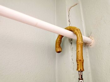 Close-up of pipe against white wall