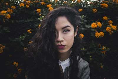 Close-up of young woman with flowers