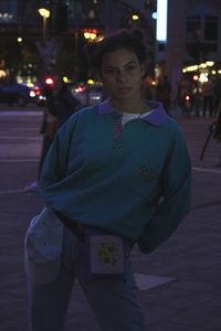 Portrait of man standing on street at night