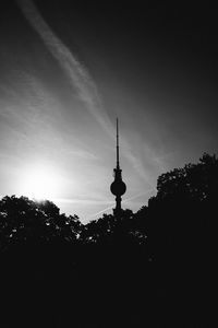 Silhouette of building against cloudy sky