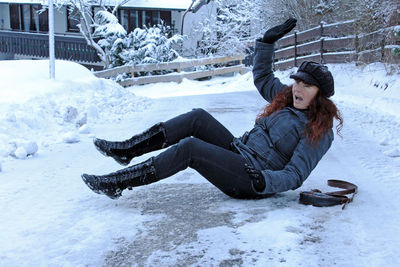 Woman in snow covered field during winter