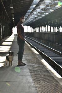 Man standing on railroad station platform