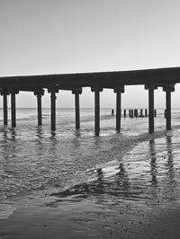 Pier over sea against clear sky