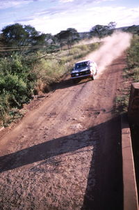 Car moving in speed on dusty road