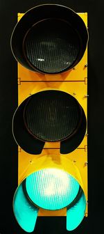 High angle view of illuminated electric lamp against black background