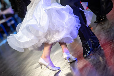 Low section of man and woman dancing on stage