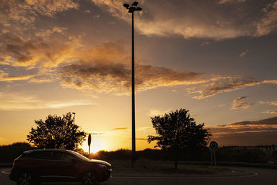 Car on street against sky during sunset