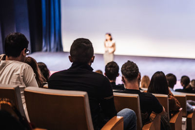 Rear view of people sitting at music concert