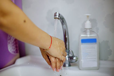 Midsection of woman holding ice cream in bathroom