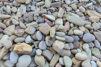 Close up of rounded and polished beach rocks on the sea shore