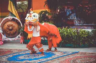 Man wearing dragon costume during festival