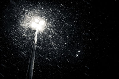 Low angle view of illuminated street light at night
