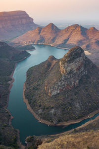 High angle view of lake and mountains against sky