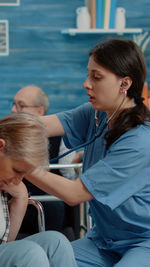 Nurse examining patient at rehab center