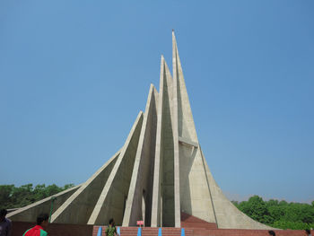 Low angle view of tower against blue sky