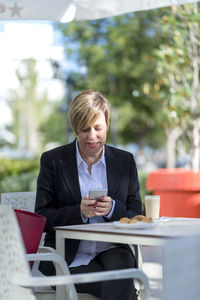 Portrait of businessman using laptop at office