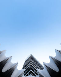 Low angle view of modern building against clear blue sky