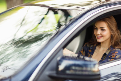 Portrait of young woman in car