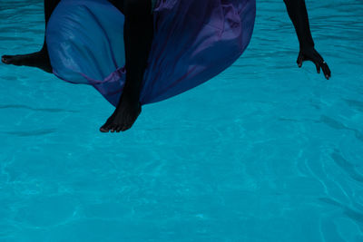 Low section of person swimming in sea