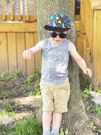 Portrait of boy standing in forest