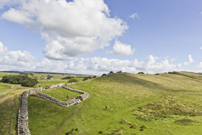 Panoramic view of green landscape against sky